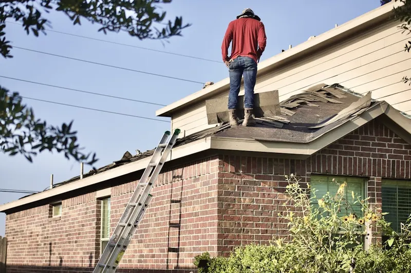 Professional roofer working on a residential roof in Empire Ranch Village
